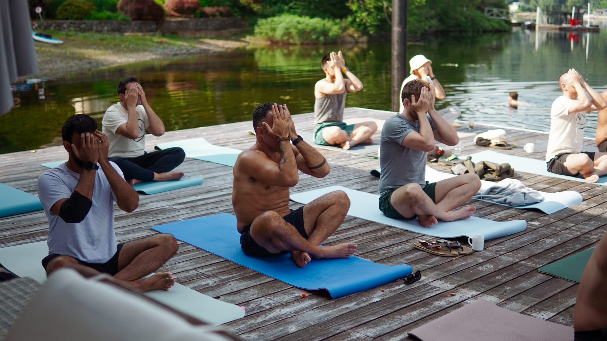 A team meditation session on the dock at the start of a corporate retreat