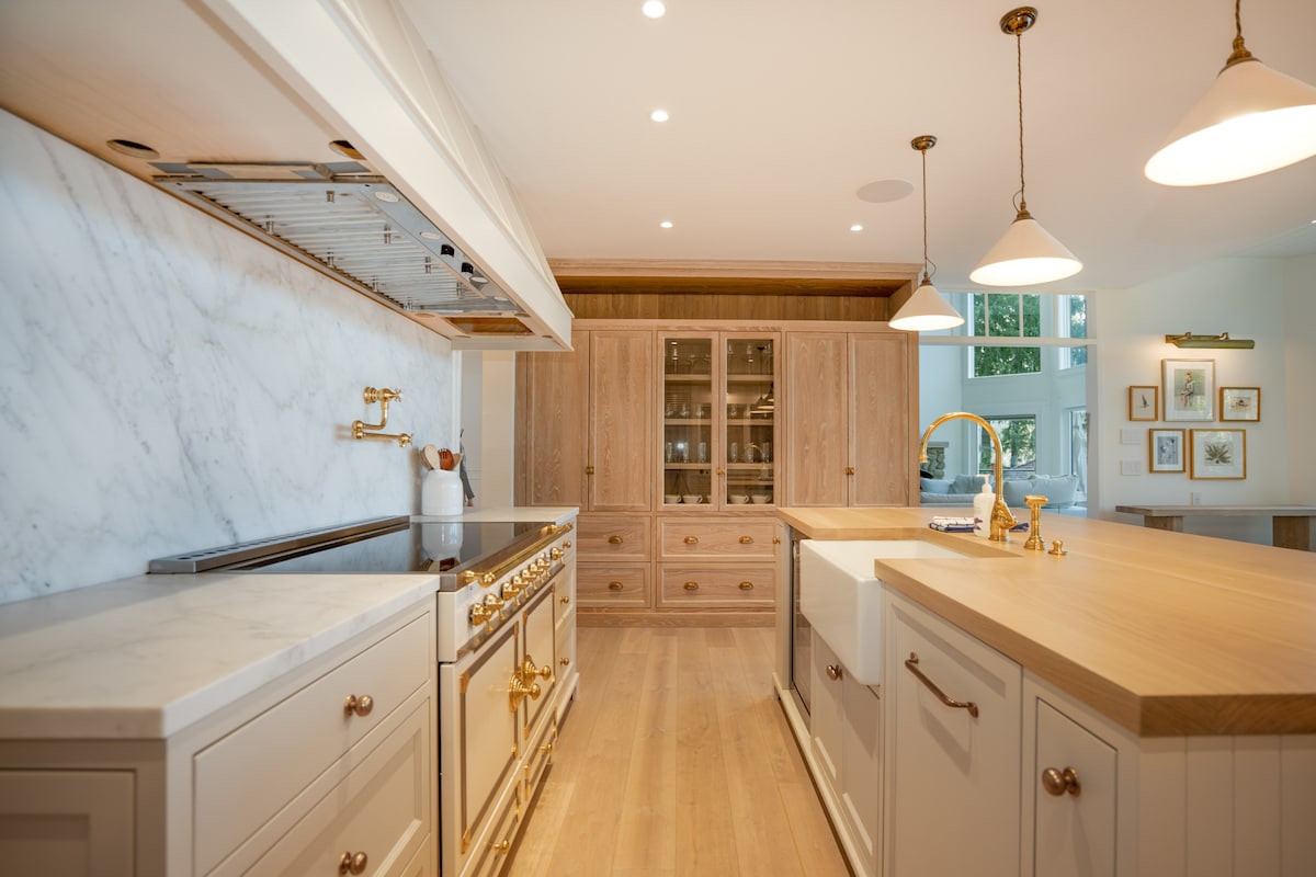 Chef's kitchen with Lacanche range, marble backsplash and oak cabinetry