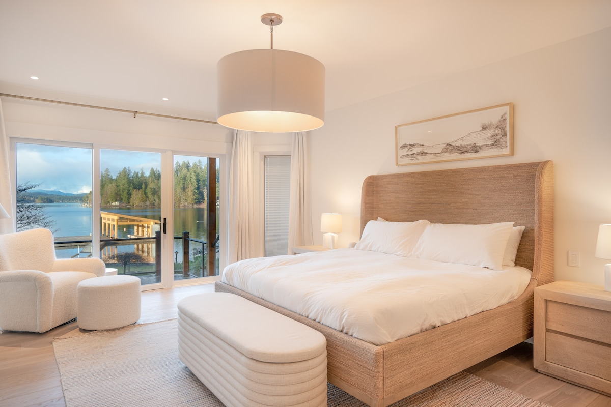Primary bedroom with king bed and lake view balcony
