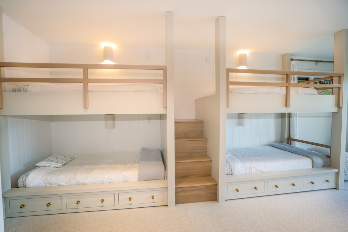 Custom bunk room with four built-in bunks and storage drawers