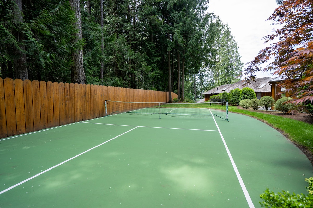 Private pickleball court surrounded by tall trees