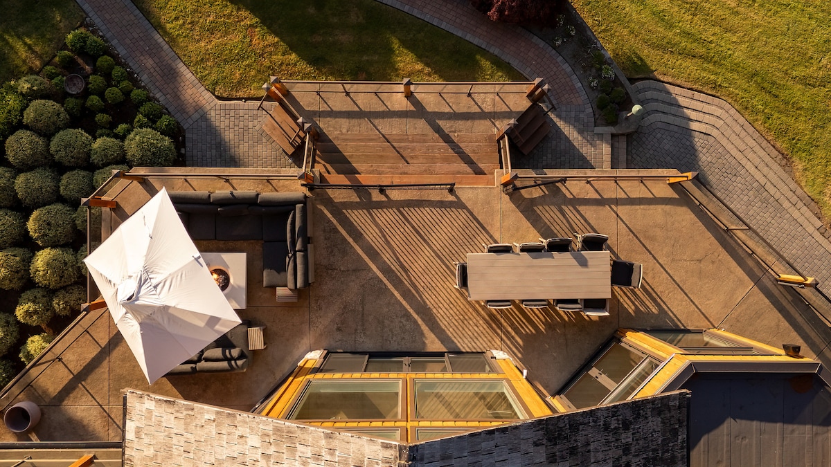 Outdoor deck aerial with dining area and skylights