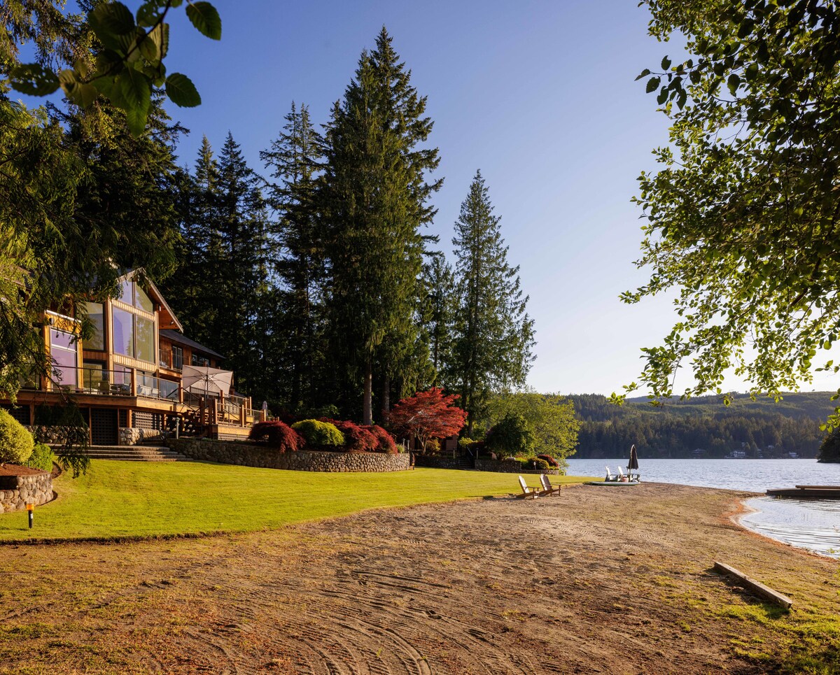 The lakeside house from the beach, lawn meeting the sand