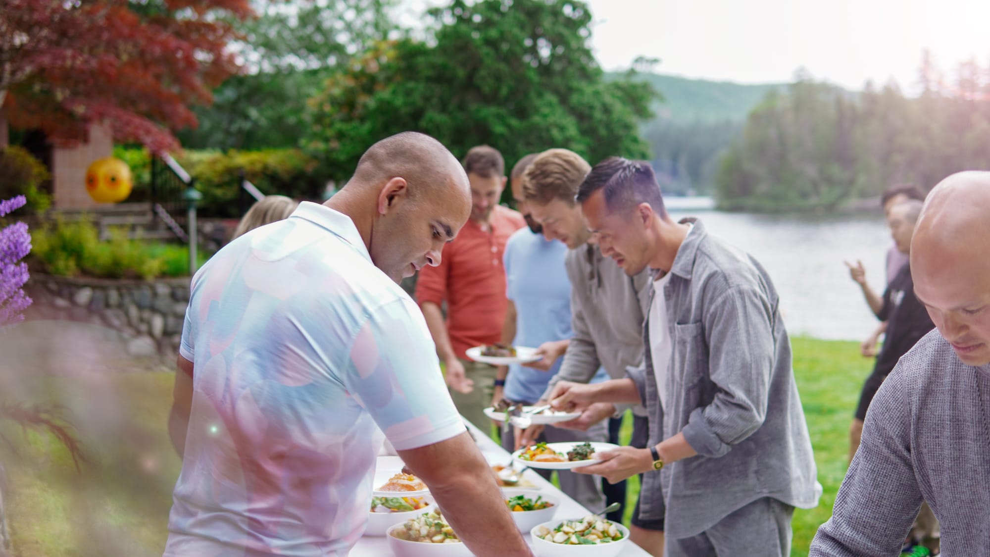 Outdoor buffet line on the lawn with the lake in the background
