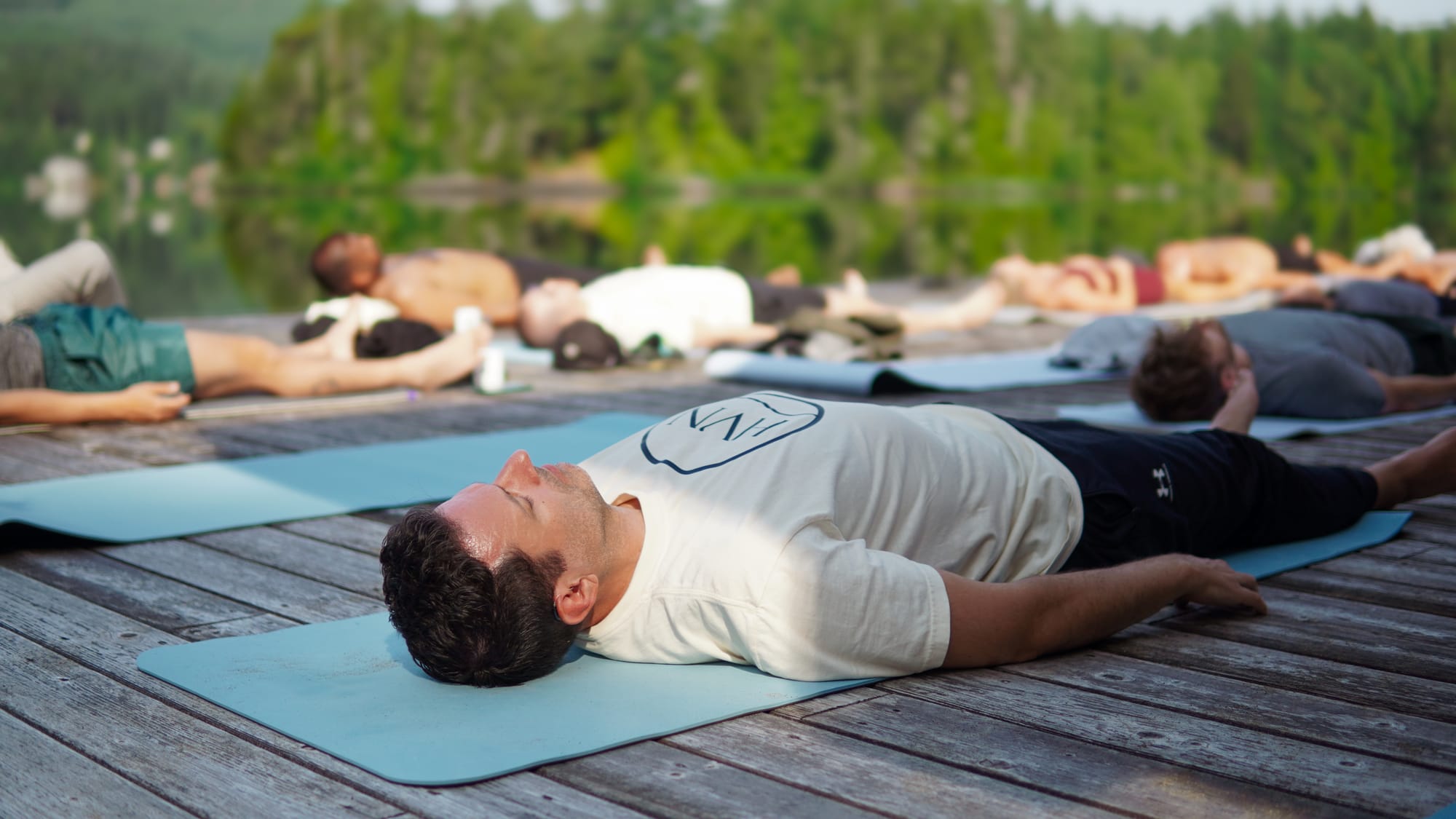 Yoga and savasana on the lakefront dock